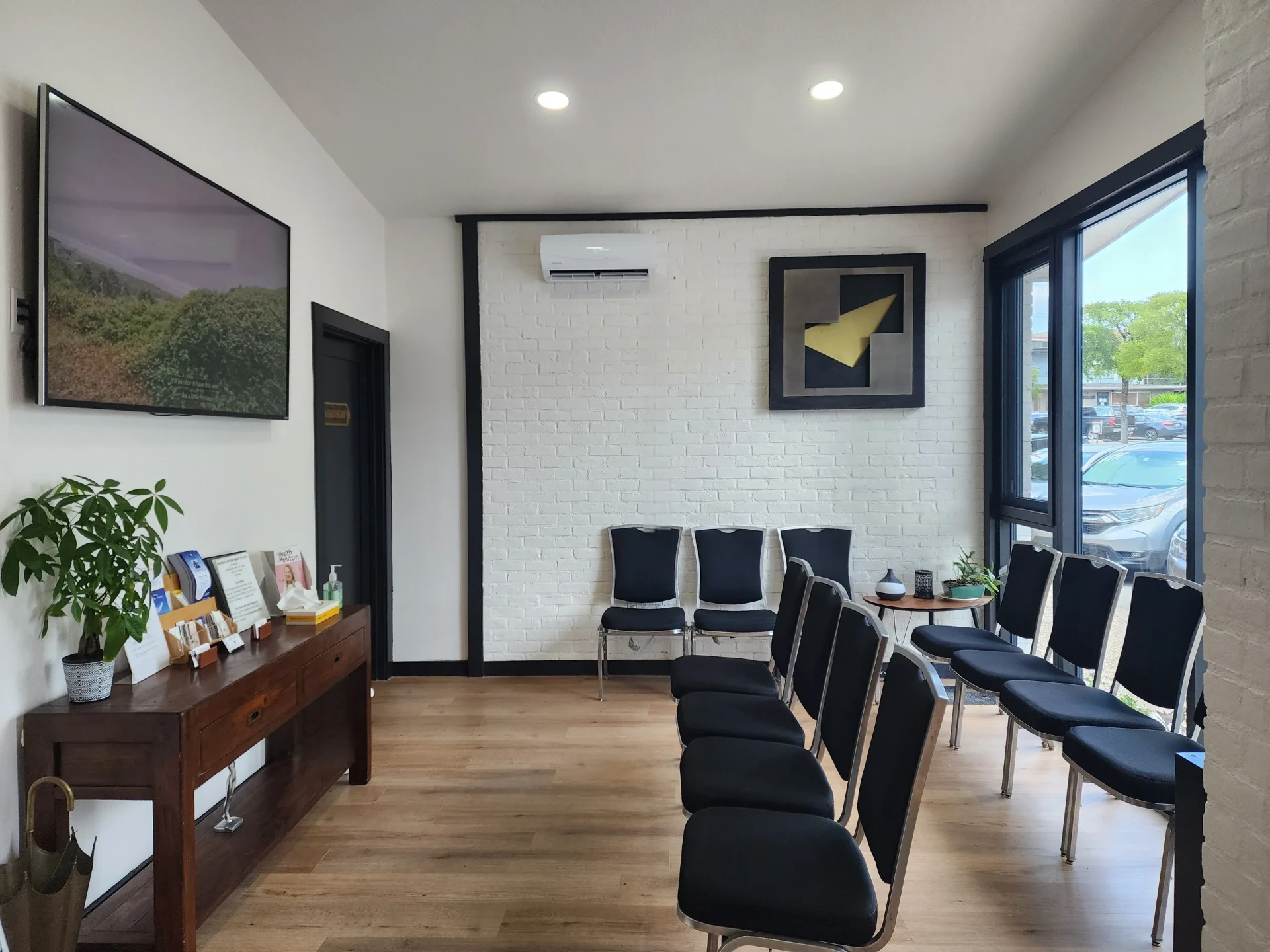 Bright, modern cardiology clinic waiting room with warm wood accents